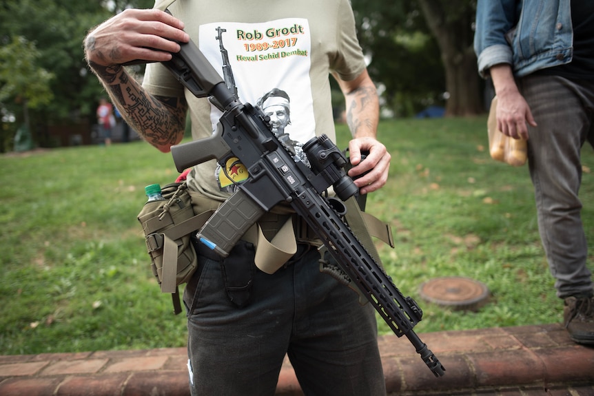 Dwayne Dixon carries an assault rifle in Charlottesville.