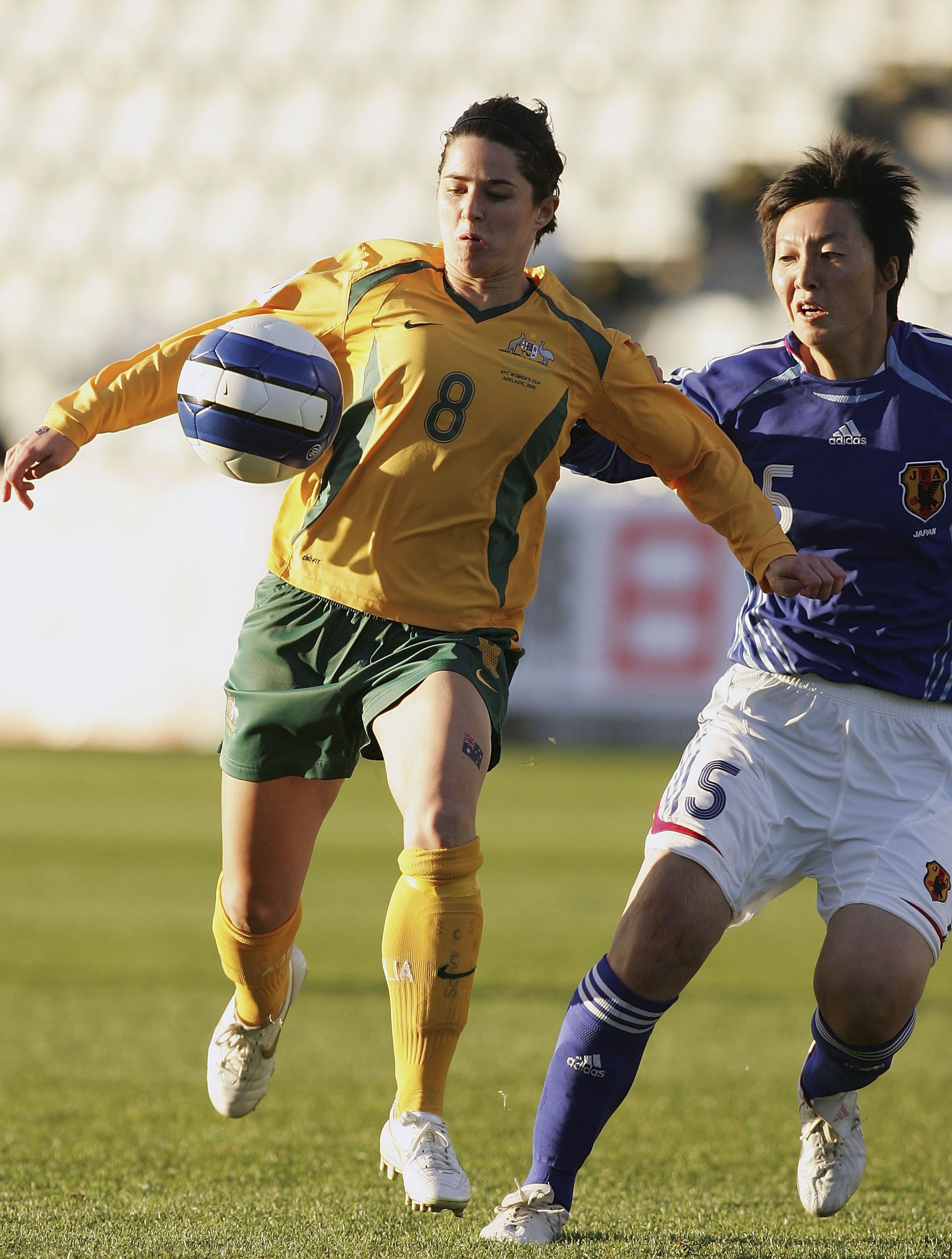Australia's Sarah Walsh battles for the ball with Kyoko Yano of Japan.