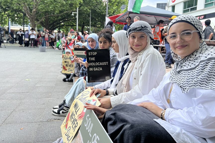 People holding signs in Canberra's city centre as part of a School Strike for Palestine.