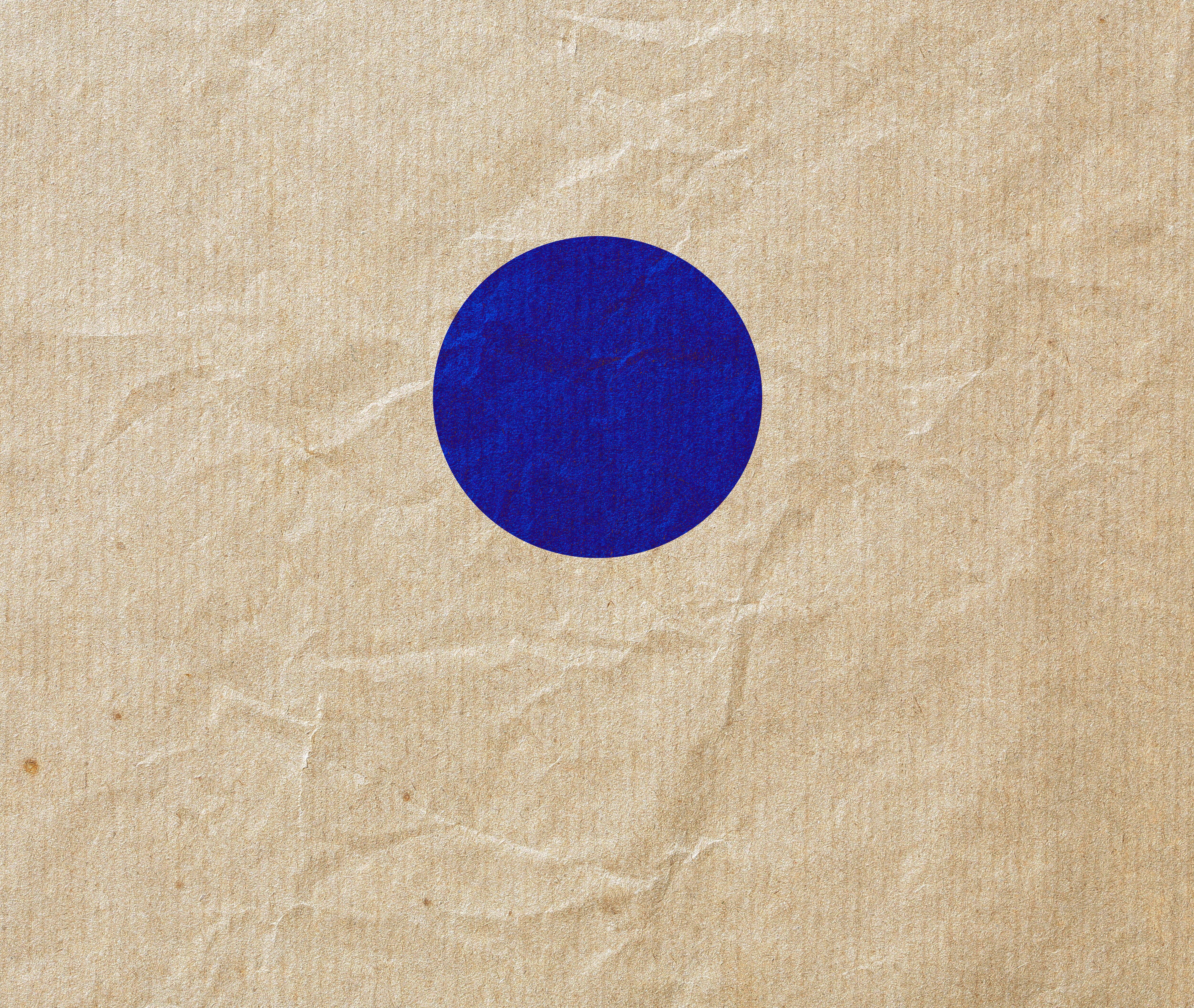 A textured beige backdrop with a blue circle