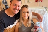 Jessica, Jakes and baby Levi in a hospital bed