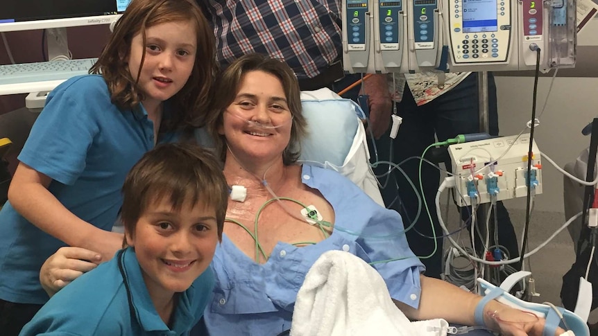Jo Dean being treated in hospital with her two children.