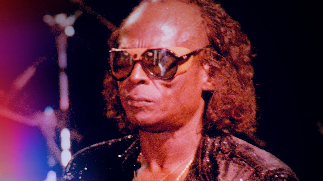 Miles Davis in the 1980s with retro glasses and long hair