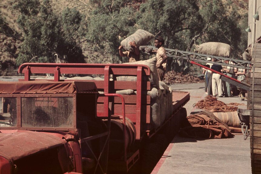Workers loading bagged asbestos at at Wittenoom in May 1961.