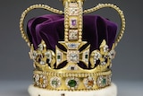A close-up of St Edward's Crown, featuring gold, purple velvet, white fur and lots of jewels