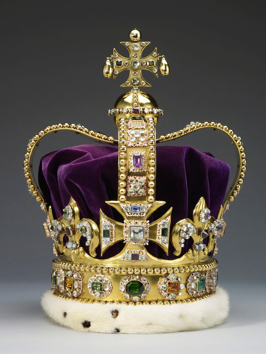 A close-up of St Edward's Crown, featuring gold, purple velvet, white fur and lots of jewels