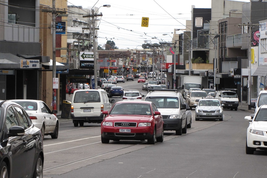 Traffic, and cars on High St Northcote, in Melbourne.