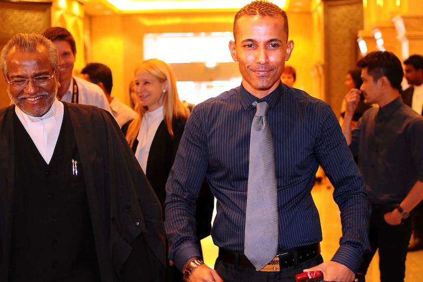 Dominic Bird (right), walks out of the courtroom accompanied by his lawyer, Muhammad Shafee.