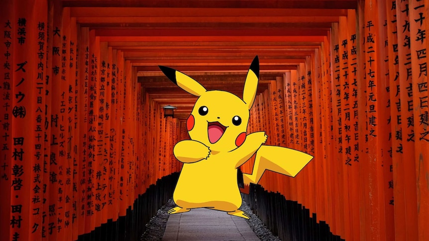Pokémon mascot Pikachu, a yellow cartoon, inside a red Shinto walkway with Japanese letters printed on wooden posts.