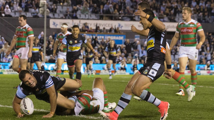 Cronulla's Wade Graham (L) scores a try against South Sydney at Shark Park.