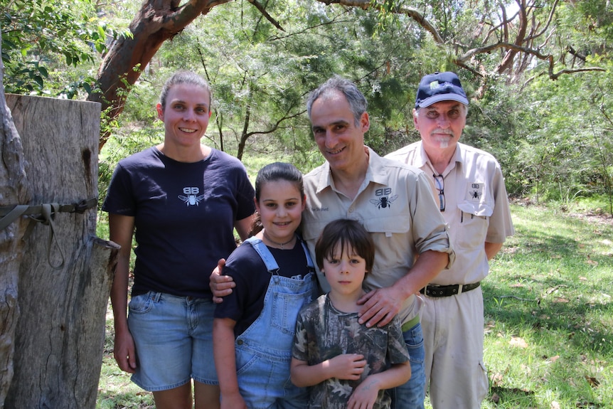 man standing with his family