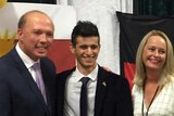 Peter Dutton smiles with Yazidi teen Haji Ilya and another woman and man