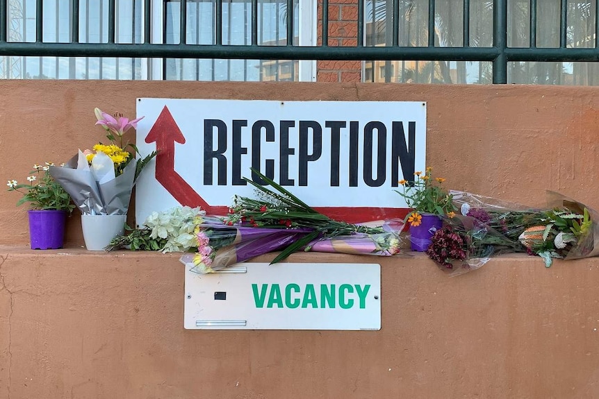 Flowers at a reception sign.