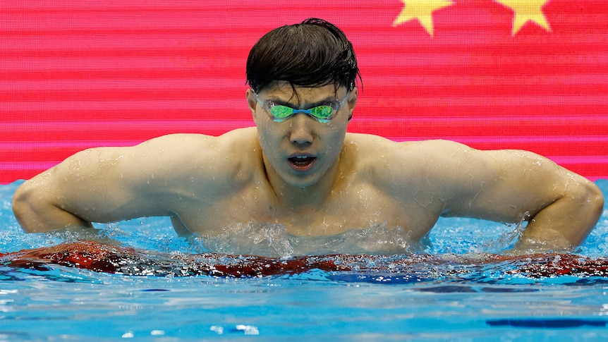 Qin Haiyang of China in the swimming pool looking determined.