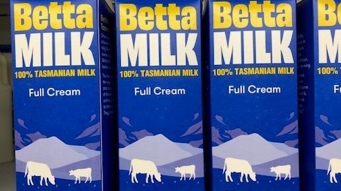 Three milk cartons of Betta Milk side by side in a supermarket in Tasmania