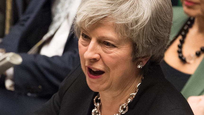 Britain's Prime Minister Theresa May reacts as she addresses the House of Commons.