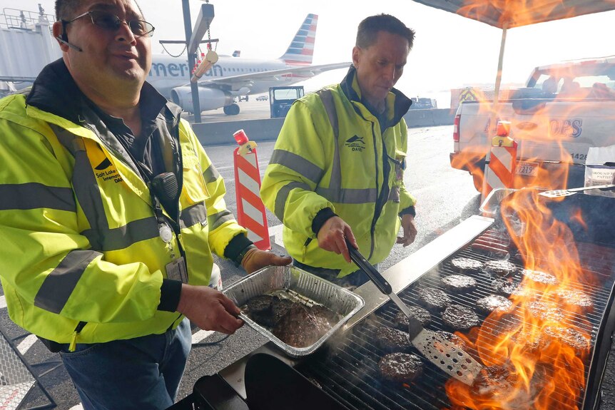Airport workers prepare a barbecue at Salt Lake City International Airport