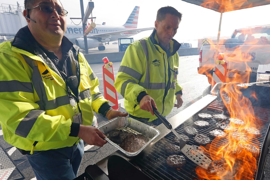 Airport workers prepare a barbecue at Salt Lake City International Airport