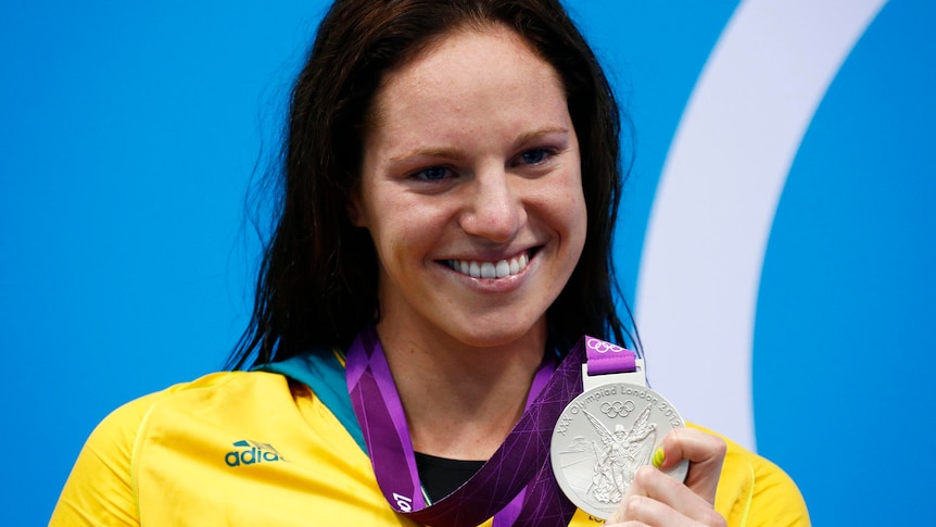 Emily Seebohm smiles with her silver medal during the women's 100m backstroke victory ceremony.