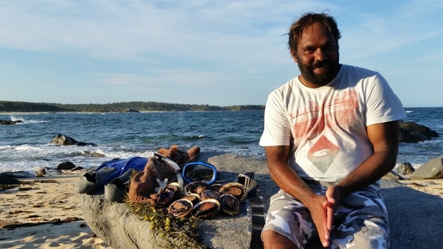 Wayne Carberry sits next to abalone he collected in waters off the NSW south coast.