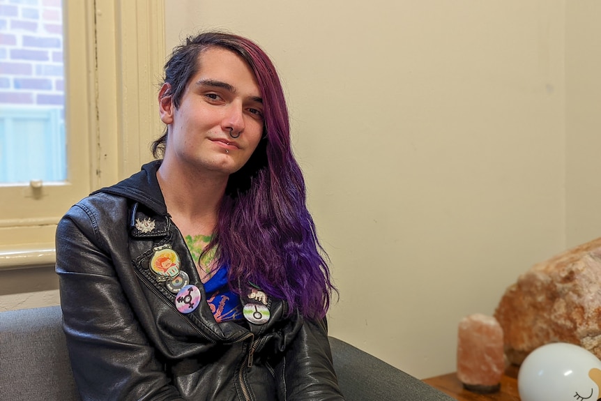 Portrait of Opal Alara with long purple hair and leather jacket in PICYS house