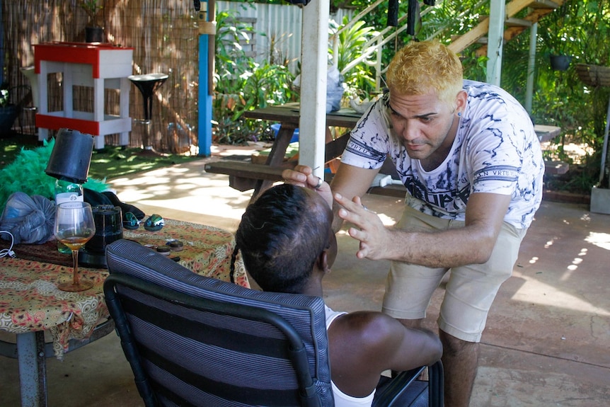 Carlos Waina helps Patrick George prepare for Mardi Gras in Broome.