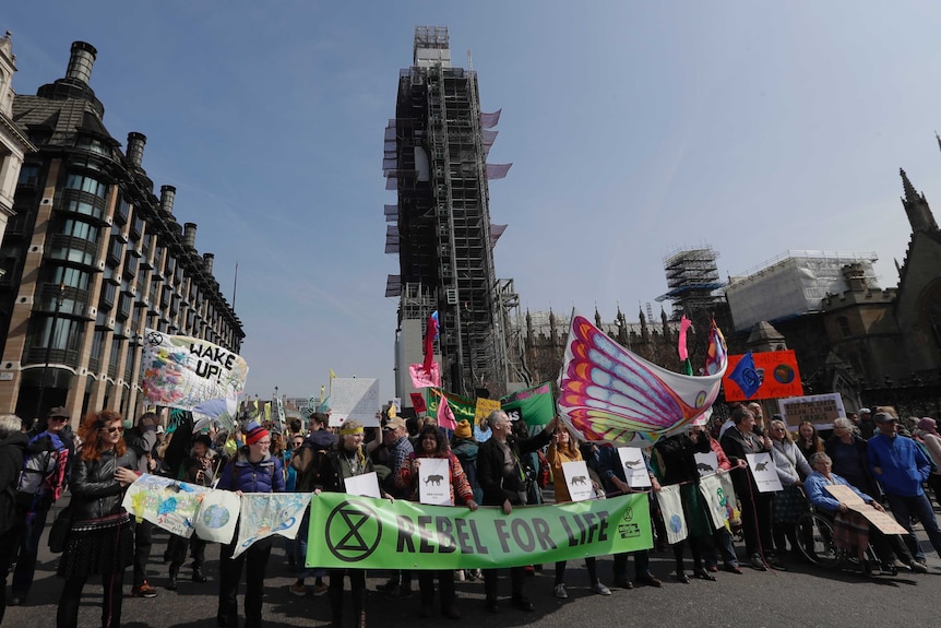 Demonstrators block the road during a climate protest in Parliament Square in London.