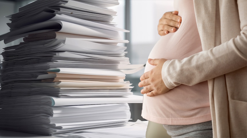 A pregnant woman faces a pile of documents