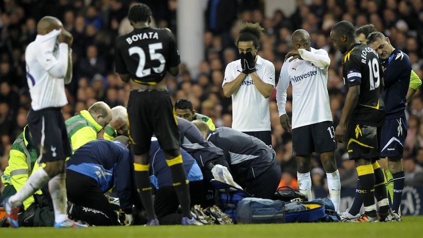 Medical staff treat collapsed Bolton midfielder Fabrice Muamba