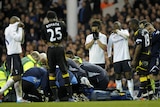 Medical staff treat collapsed Bolton midfielder Fabrice Muamba