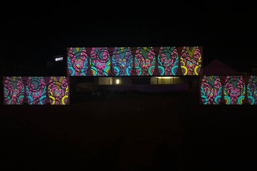 colourful contemporary indigenous art work projected on three shipping containers