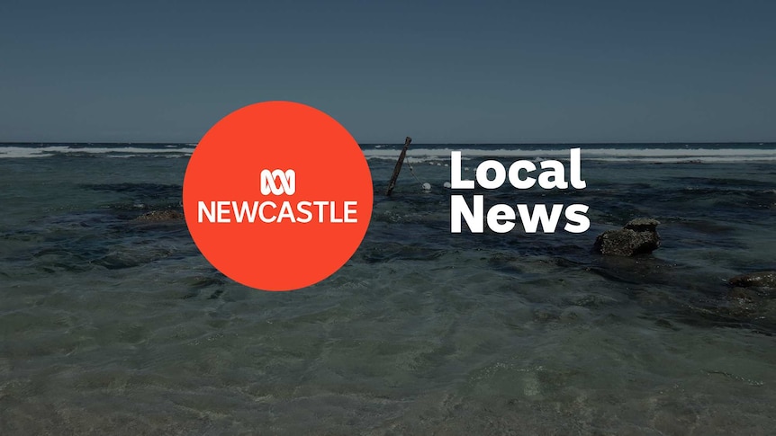 Shallow ocean water covering sand and rocks, with ABC Newcastle and Local News superimposed over the top.