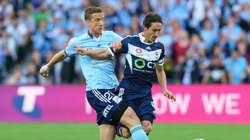 Mark Milligan battles with Marc Janko