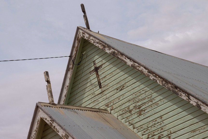The peaked gables of an old church building in Ivanhoe, showing signs of wear.