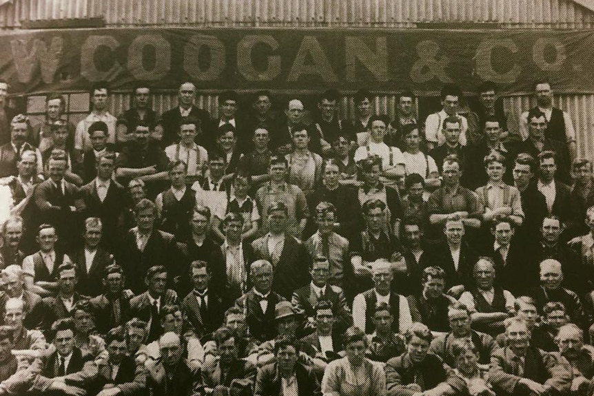 Staff lined up outside factory.