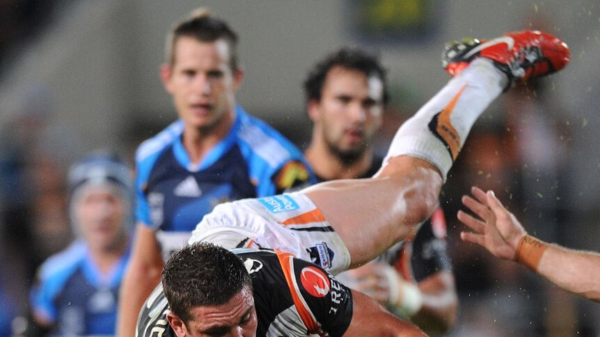 Collared: Greg Bird is hammered by the Tigers' defence.