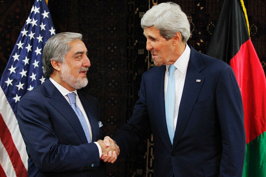 Abdullah Abdullah shakes hands with US secretary of state John Kerry