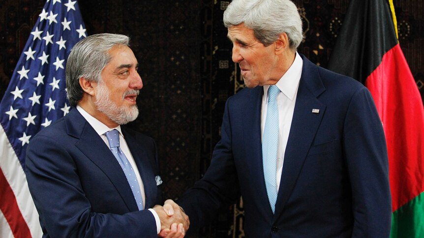 Abdullah Abdullah shakes hands with US secretary of state John Kerry