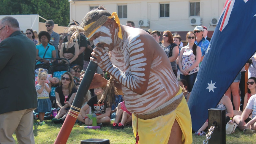 Kalkadoon man Ronaldo Gavara plays the didgeridoo in traditional dress at the Mount Isa Anzac ceremony