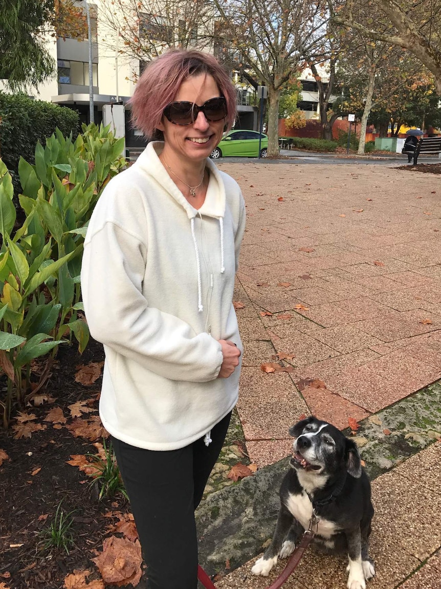 Justine Colyer with her dog Melba on a lead next to her.