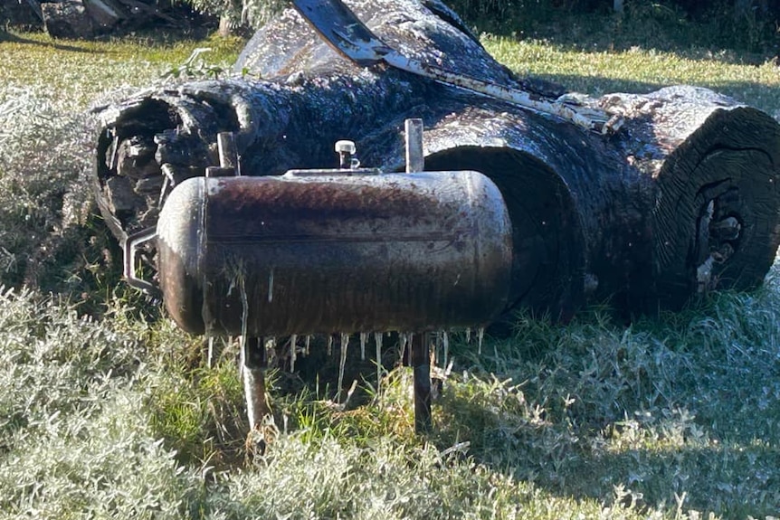 A BBQ smoker with icicles dripping from it
