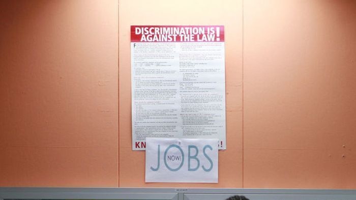 A man looks at employment opportunities at a jobs centre.