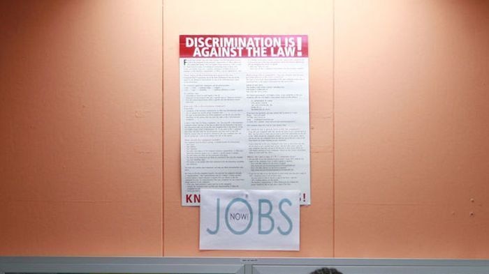 A man looks over employment opportunities at a jobs centre.