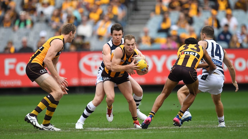 Tom Mitchell is tackled by Patrick Dangerfield