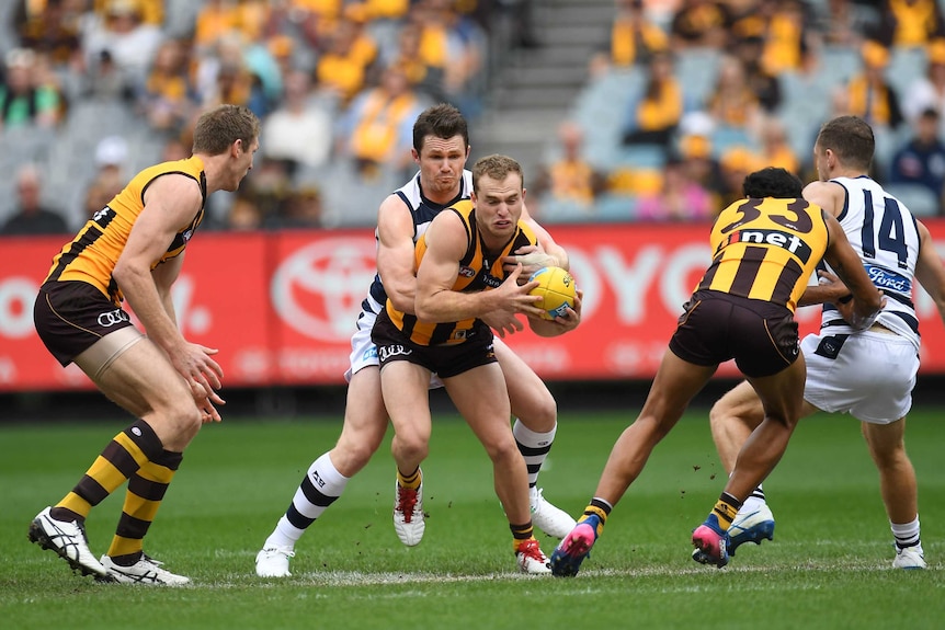 Tom Mitchell is tackled by Patrick Dangerfield