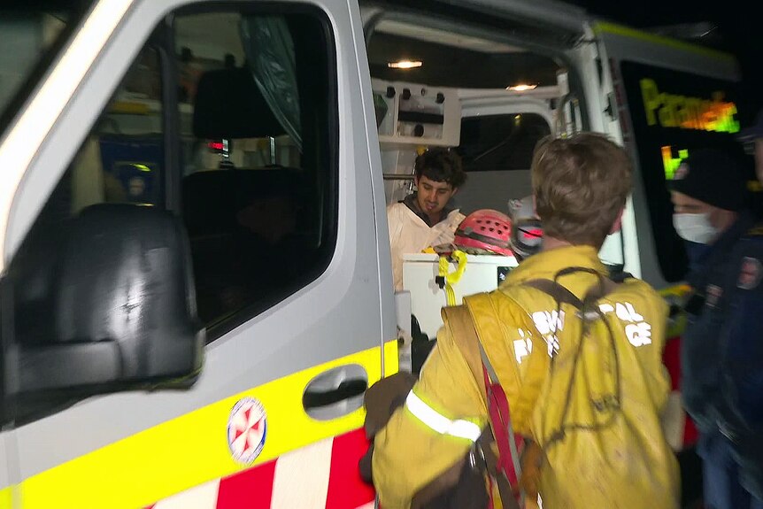 a man sits inside a nsw ambulance after being rescued from the jenolan caves 