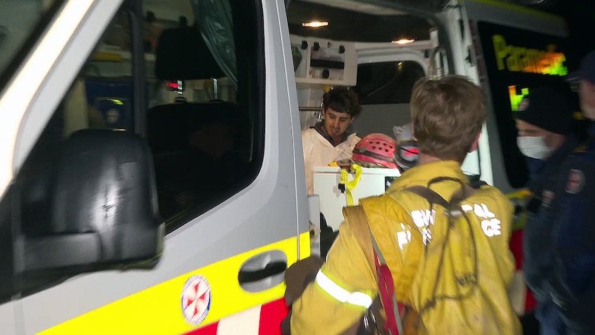 a man sits inside a nsw ambulance after being rescued from the jenolan caves 