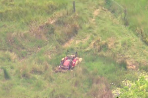 A red tractor in a grassy field