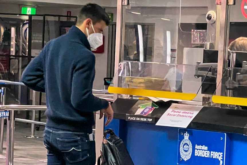 Novak Djokovic, wearing a jumper and jeans, at a Border Force station.