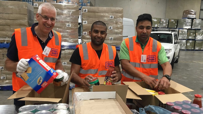 Ford workers help pack food hampers in Melbourne